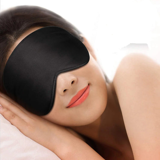 Silk Sleep Mask worn by woman lying down, showcasing its smooth texture and light-blocking design for restful sleep. Ideal for travel or home use.